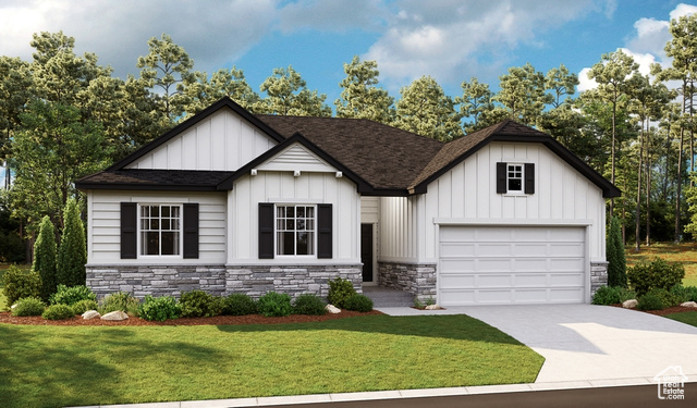 View of front of property featuring a garage and a front yard