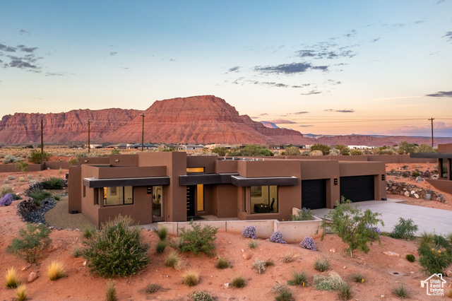 Pueblo revival-style home featuring a mountain view and a garage