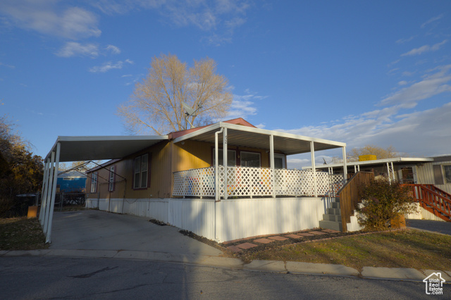 View of front of property with a carport