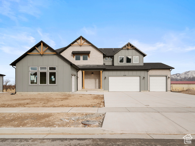 View of front of property featuring a mountain view and a garage