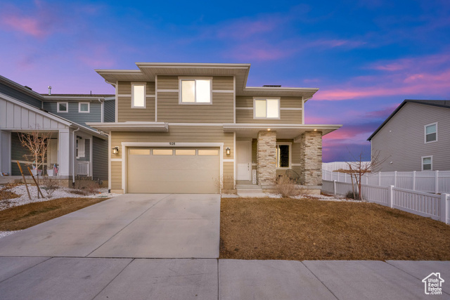 View of front facade featuring a garage