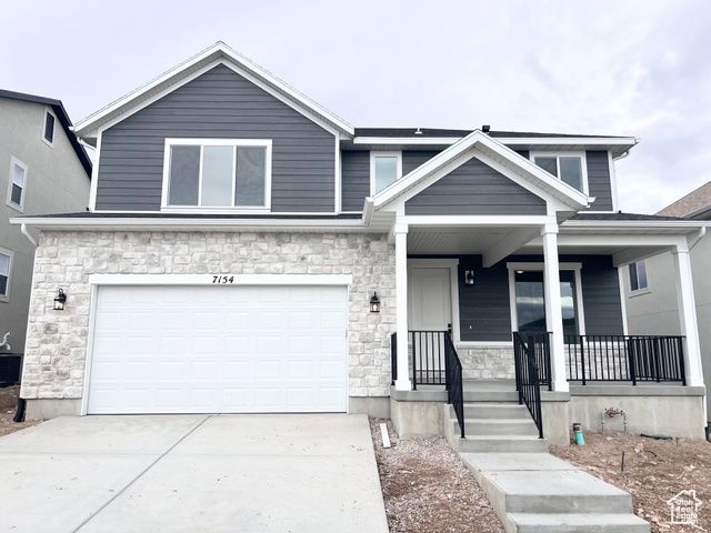 A EXTERIOR; B & D EXTERIOR STLYES NOT SHOWN. View of front facade with covered porch, central AC unit, and a garage