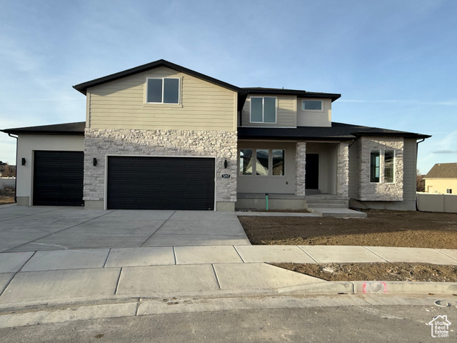 View of front of property featuring a garage