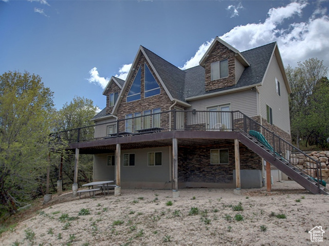 Rear view of property featuring a large deck