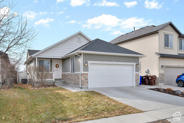 View of front facade with a front lawn and a garage