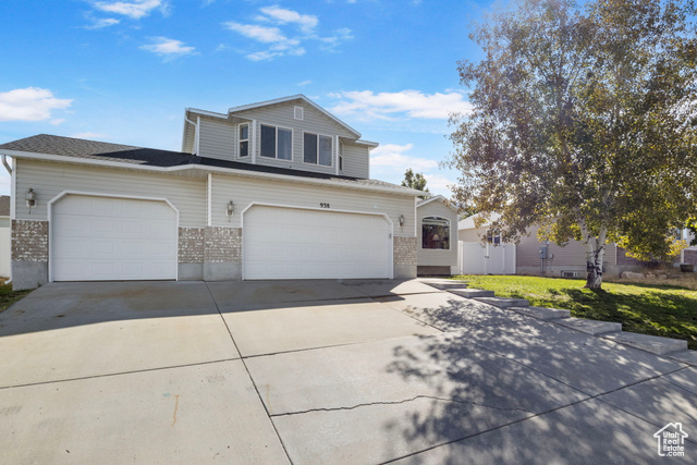 Front of property with a front lawn and a garage