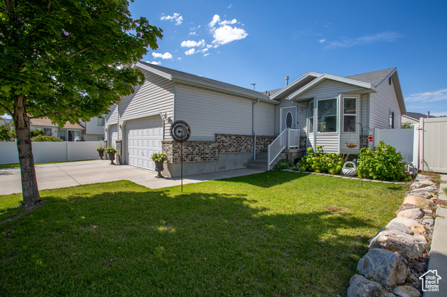 View of front of home featuring a garage and a front lawn