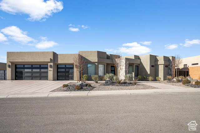 Pueblo revival-style home with a garage