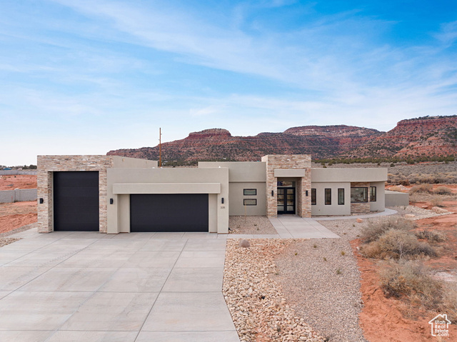 View of front of property featuring a mountain view and a garage