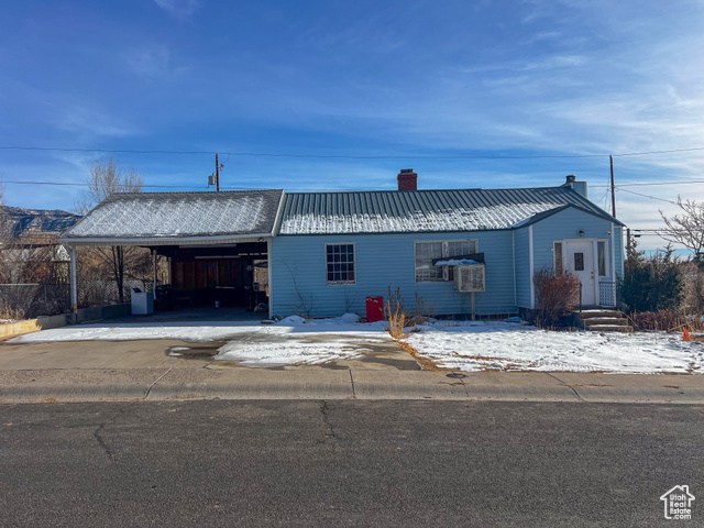 Single story home featuring a carport