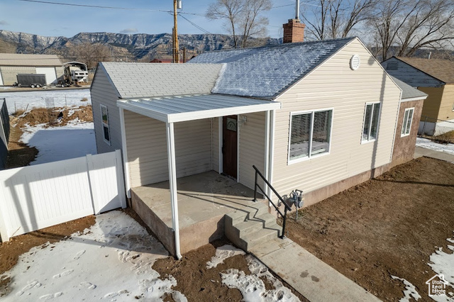 Snow covered property featuring a mountain view