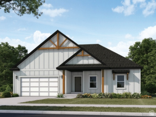 View of front facade featuring a garage and a front yard