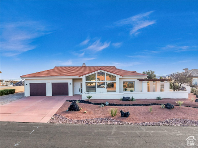 Mediterranean / spanish-style house featuring a garage