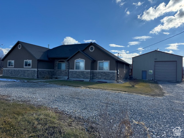 View of front of property featuring an outbuilding and a garage