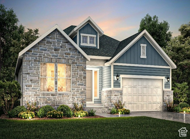 View of front of home with a yard and a garage