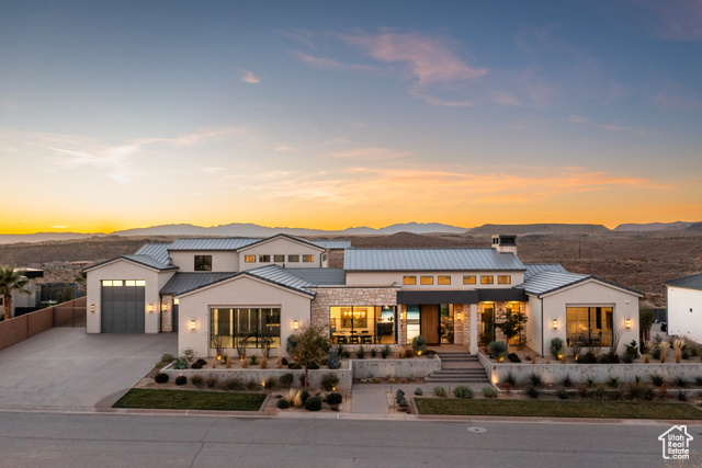 View of front of home with a mountain view and a garage