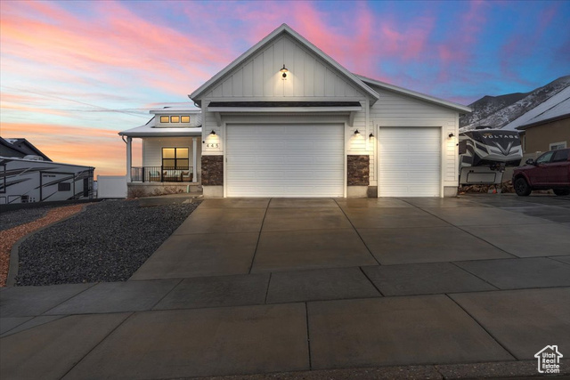 View of front facade with covered porch and a garage