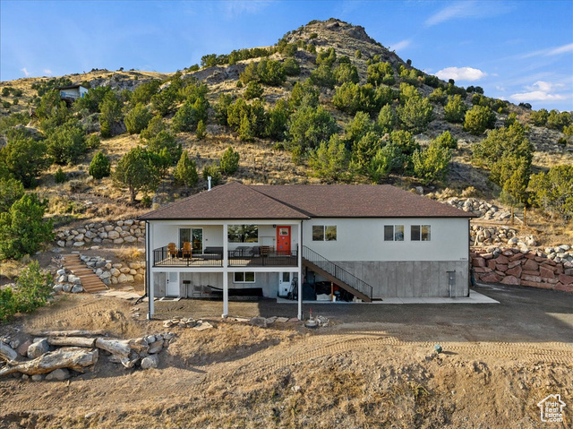 Rear view of property featuring a deck with mountain view