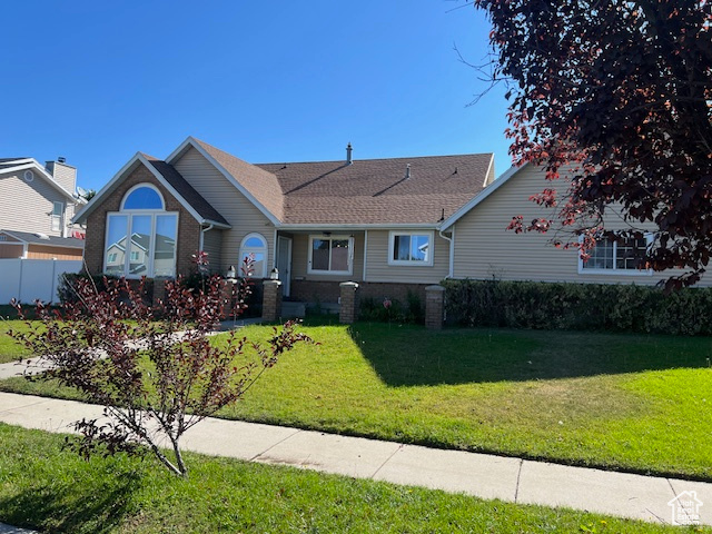 Single story home with a front yard