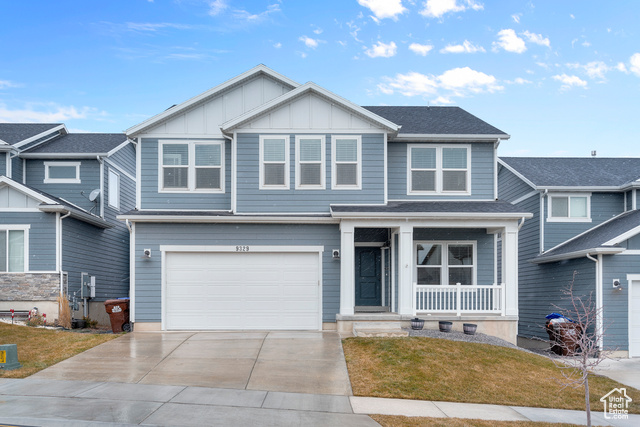 View of front of property with a garage and a front yard