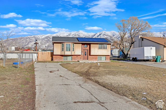 Bi-level home with a mountain view and solar panels