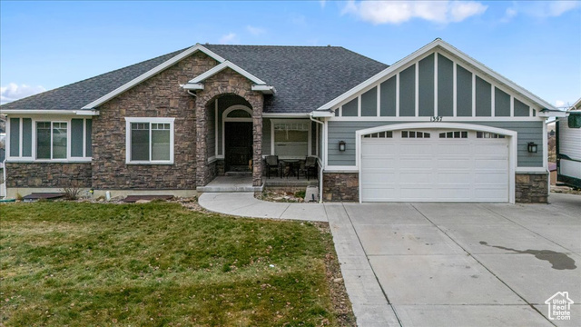 View of front of house with a front lawn and a garage