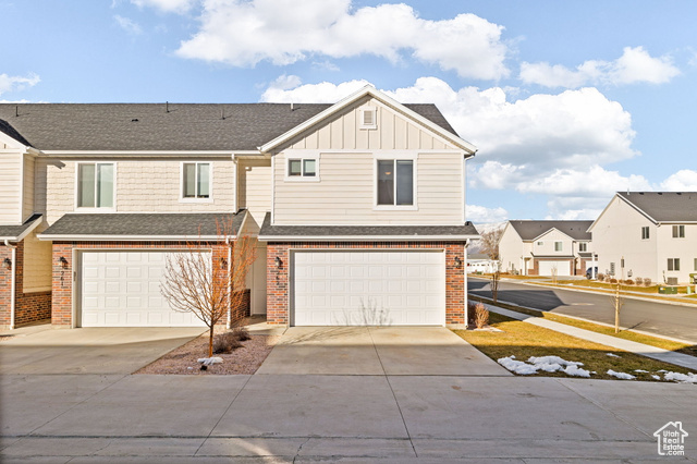 Townhome / multi-family property featuring a garage