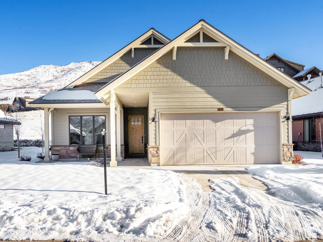 Craftsman house featuring a mountain view and a garage