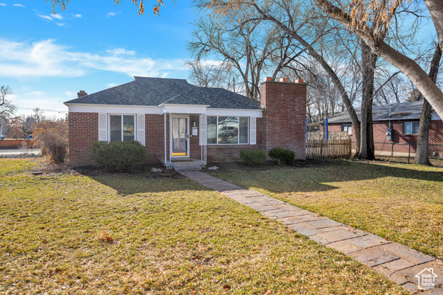 View of front of home with a front yard and new roof. Mountain views.