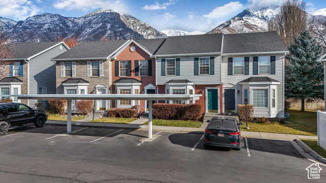 Townhome / multi-family property with a mountain view