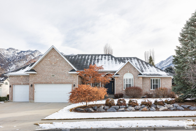 View of front of property featuring a mountain view and a garage