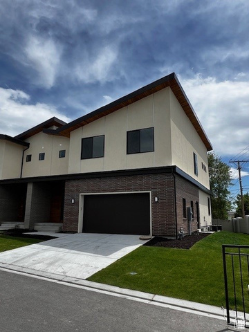 Modern home with a garage and a front lawn