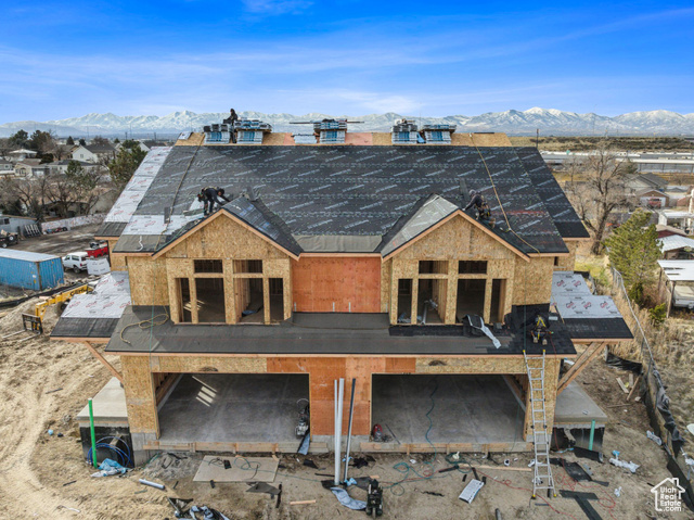 Rear view of property with a mountain view