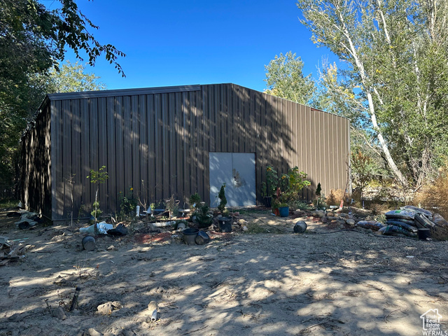 View of home's exterior featuring an outdoor structure