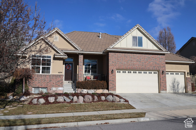 View of front of property featuring covered porch and a garage