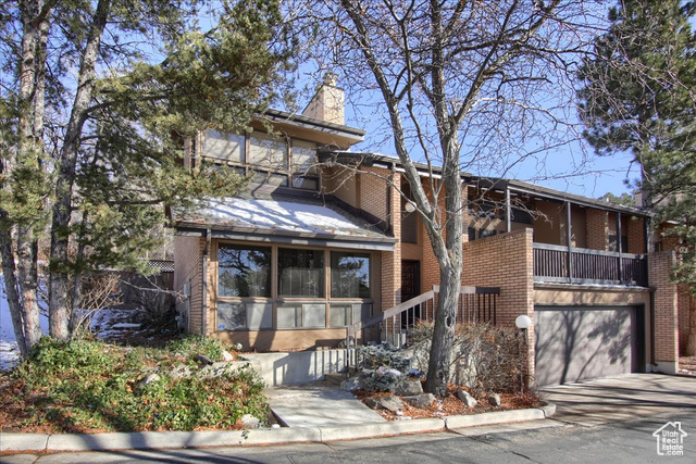 View of front of home with a balcony and a garage