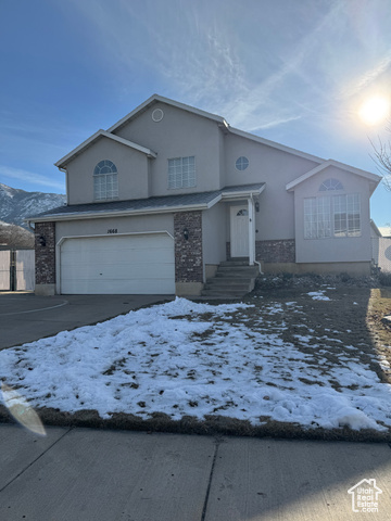 Front of property featuring a mountain view and a garage