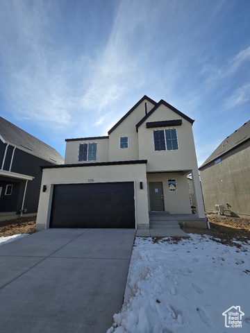 View of front facade featuring a garage