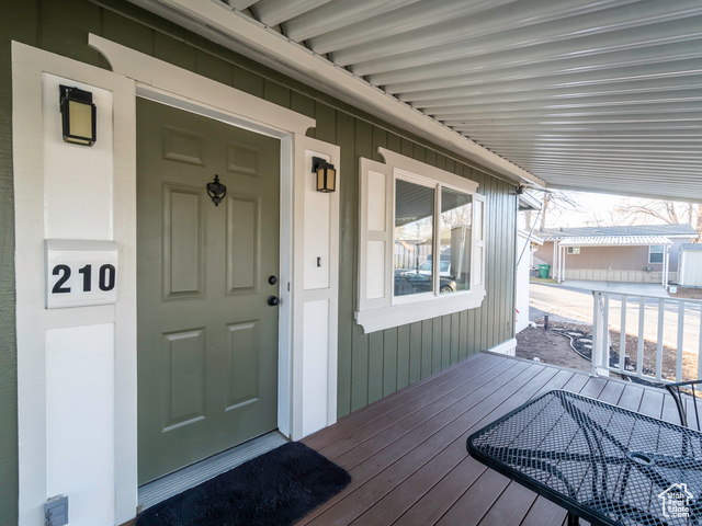 Doorway to property featuring a porch