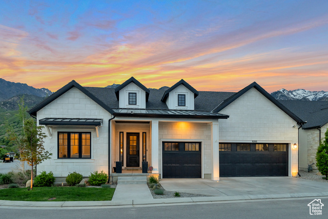 View of front of property with a mountain view and a garage