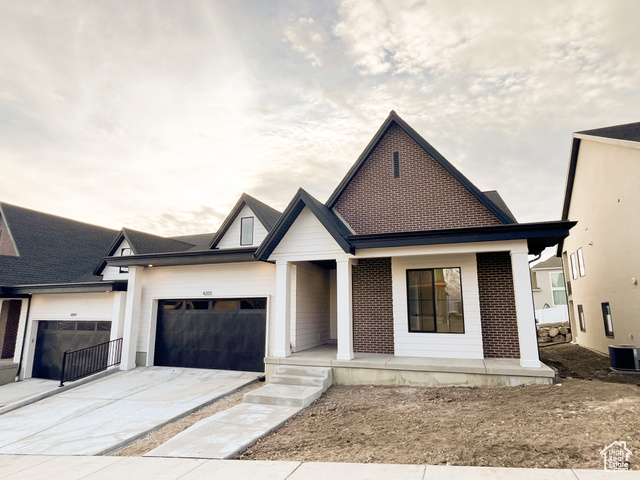 View of front of home featuring a porch and central AC