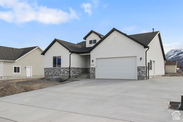 View of front of property featuring a mountain view and a garage