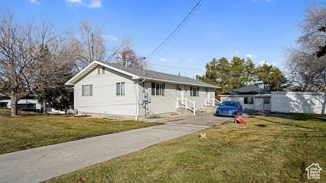 House and carport and duplex in background