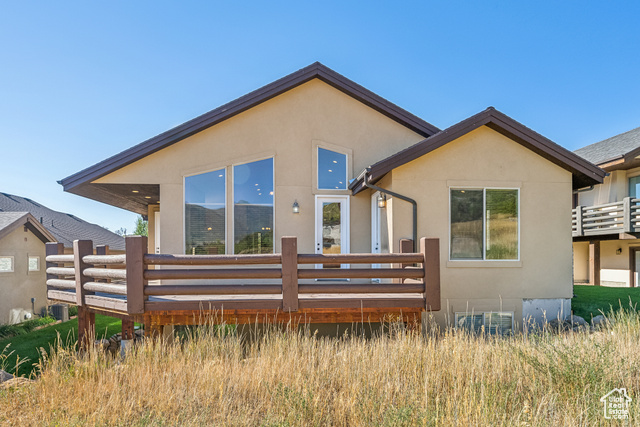 Back of house with a wooden deck