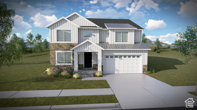 View of front facade featuring a garage and a front yard