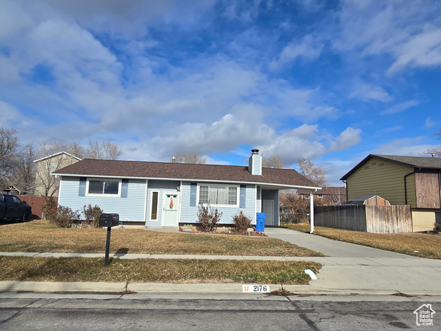 View of front of property with a carport