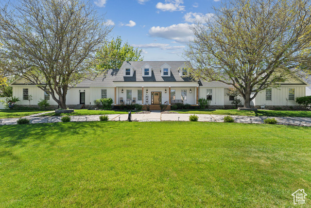 Cape cod-style house with a front lawn