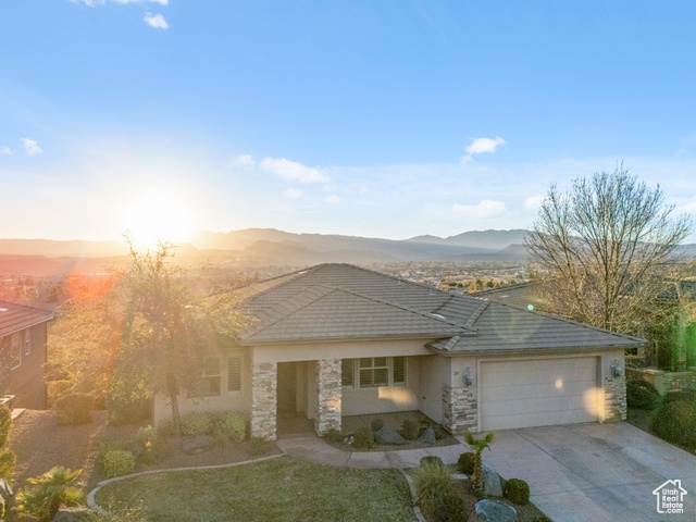 View of front of home featuring a mountain view and a garage