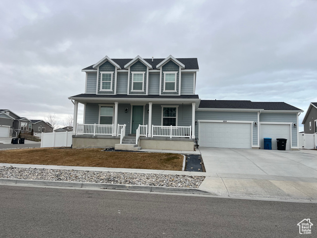 View of front of house featuring a porch and a garage