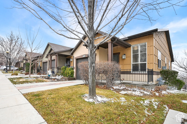 View of front of home with a garage and a front yard